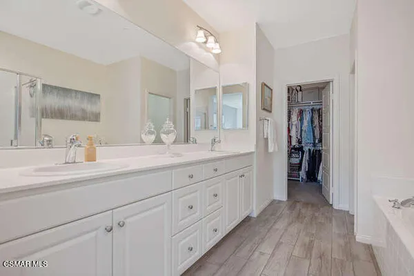 a spacious bathroom with a double vanity sink and a mirror