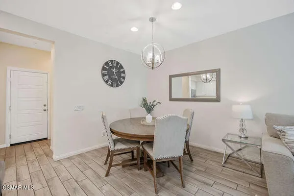 a view of a dining room with furniture wooden floor and a chandelier