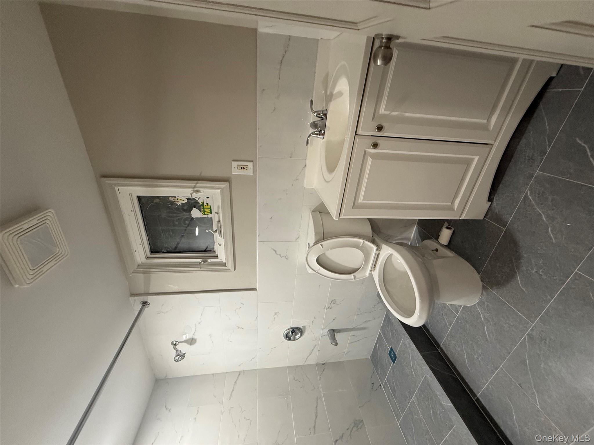 101-58 120th Street Queens, NY 11419 - Photo 2 of 9 a bathroom with a granite countertop toilet sink and mirror