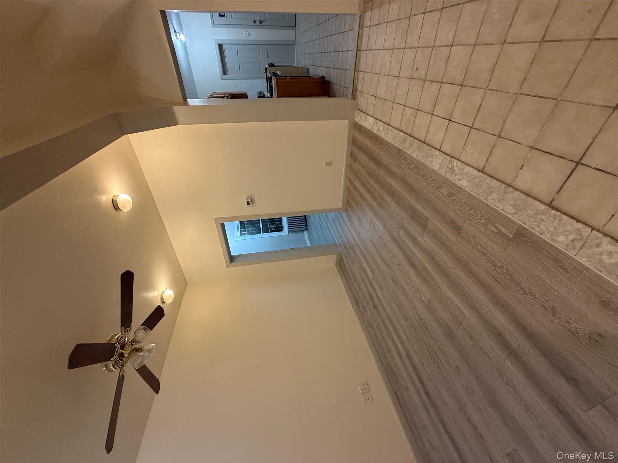 101-58 120th Street Queens, NY 11419 - Photo 6 of 9 a view of a livingroom with a dishwasher cabinets and window