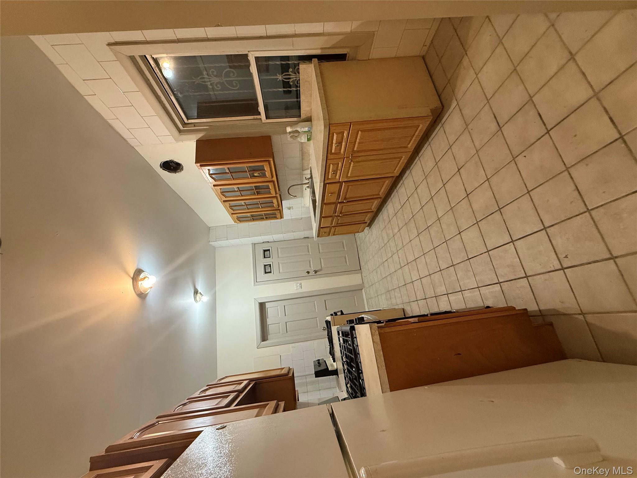 101-58 120th Street Queens, NY 11419 - Photo 7 of 9 a kitchen with stainless steel appliances granite countertop a refrigerator and a stove top oven