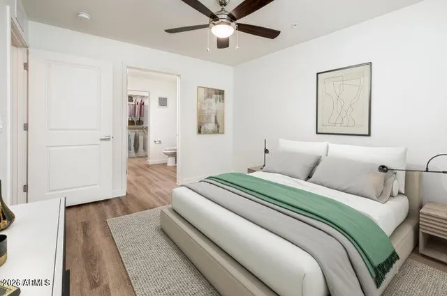 a bedroom with a large bed and a ceiling fan