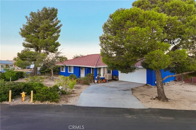 a front view of a house with yard porch and sitting area