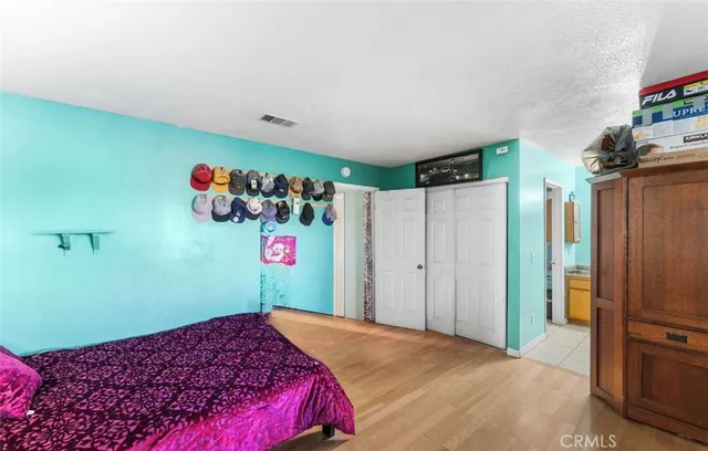 a bedroom with a bed and a painting on the wall