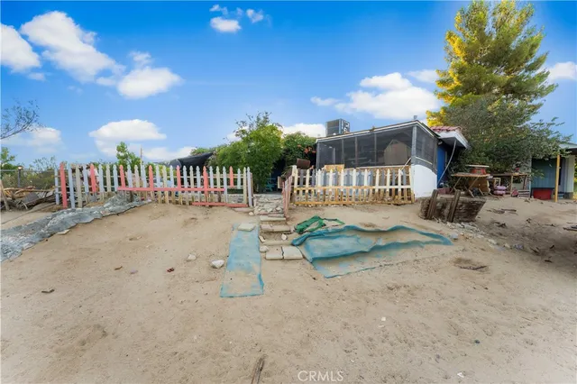 a view of a patio with table and chairs and potted plants