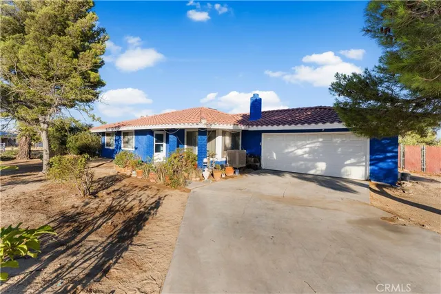 a view of a house with a yard and sitting area