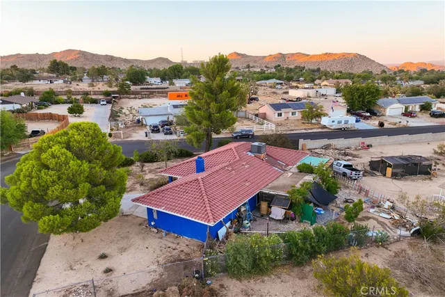 a view of a houses with a yard and green space