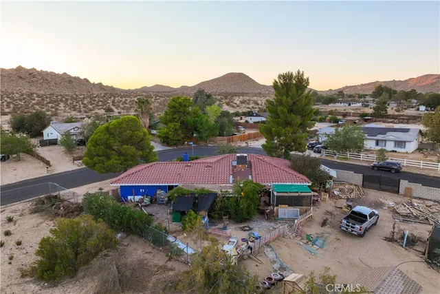 a view of a street with a houses in the background