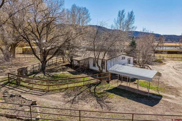 a view of a deck with wooden fence and a bench