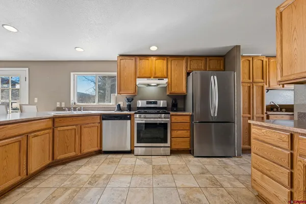 a kitchen with a refrigerator and a sink