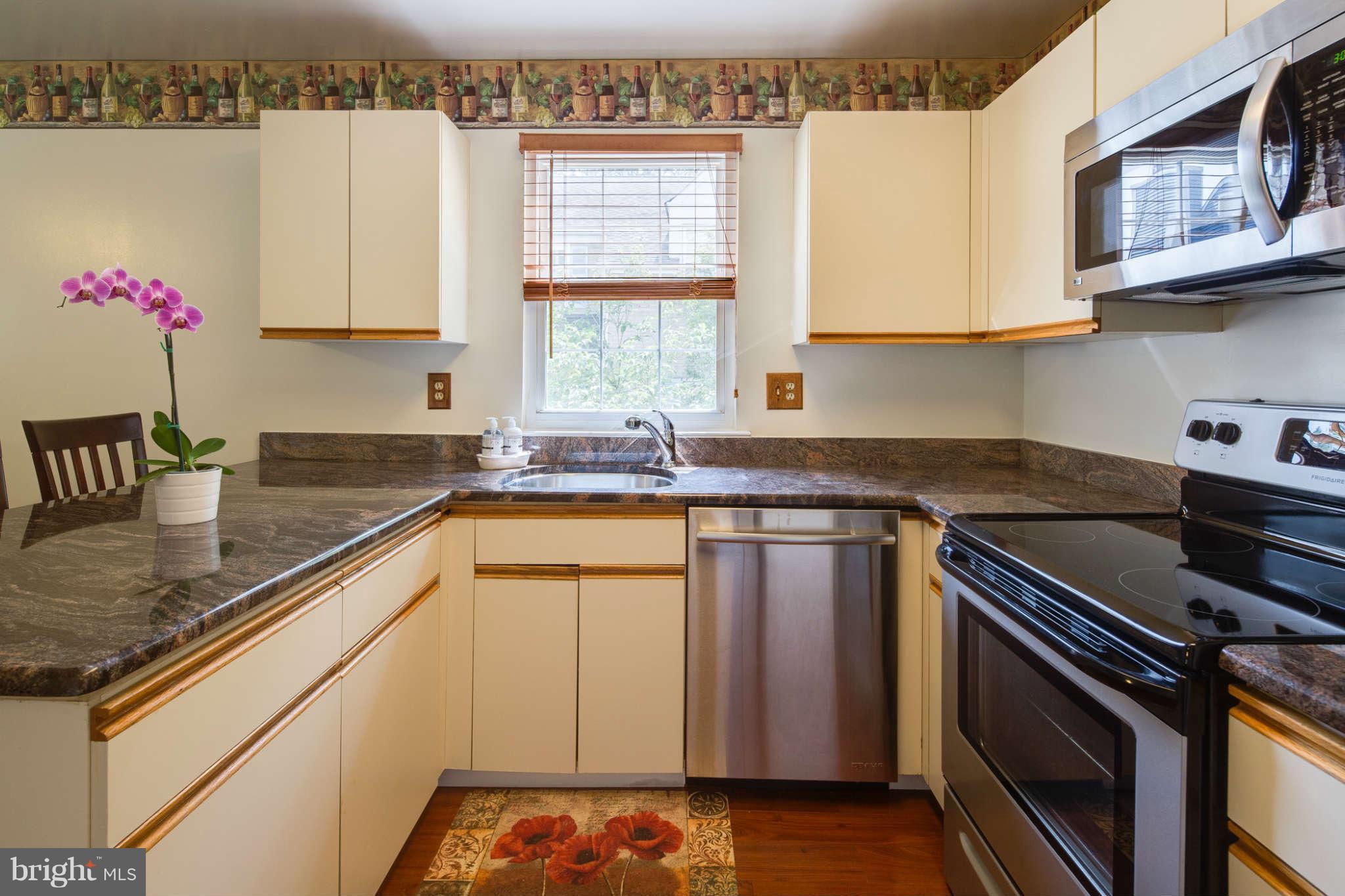 7330 Kindler Road Columbia, MD 21046 - Photo 11 of 28 a kitchen with stainless steel appliances granite countertop a sink stove and cabinets