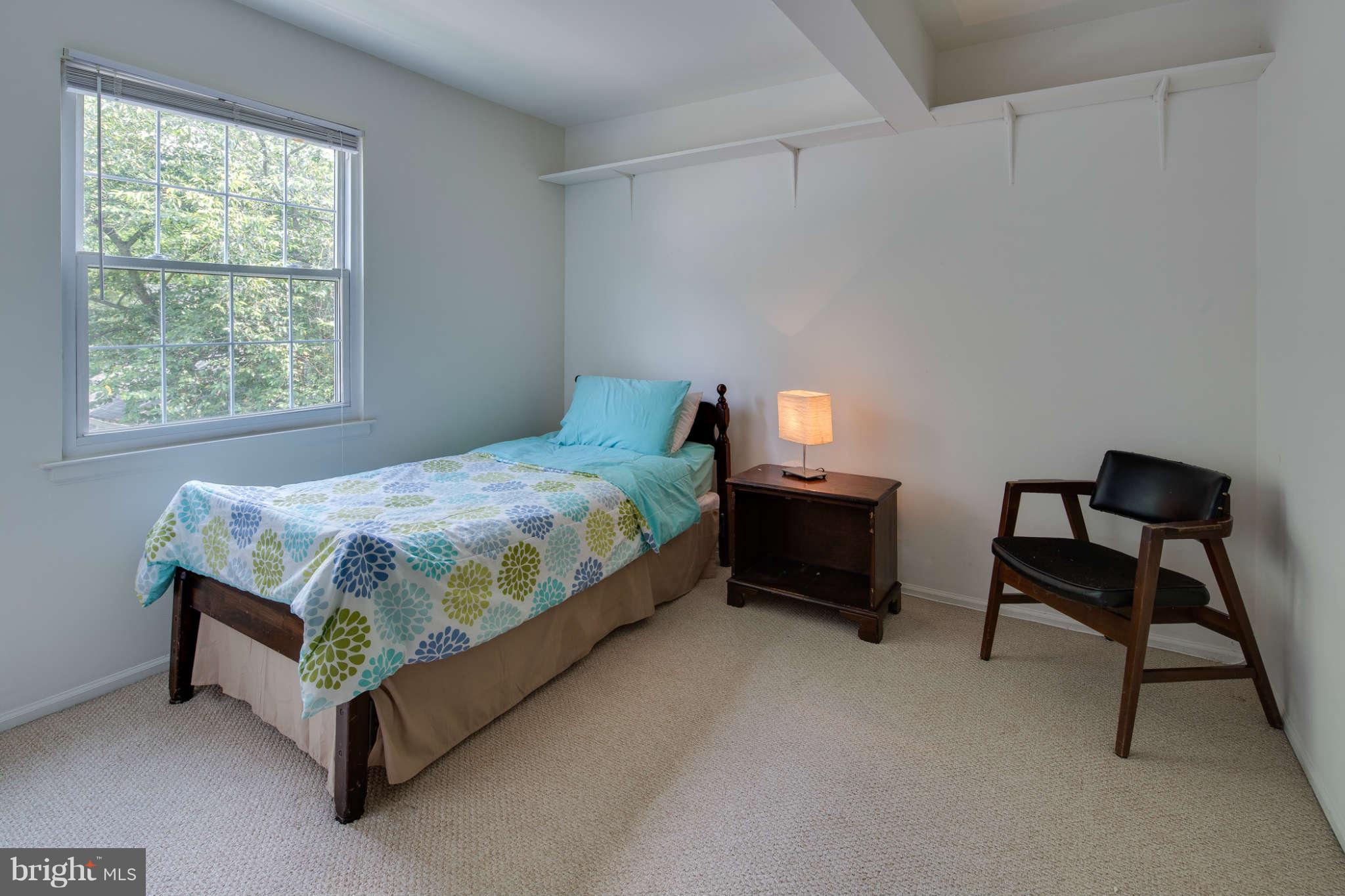 7330 Kindler Road Columbia, MD 21046 - Photo 18 of 28 a bed sitting in a bedroom next to a window