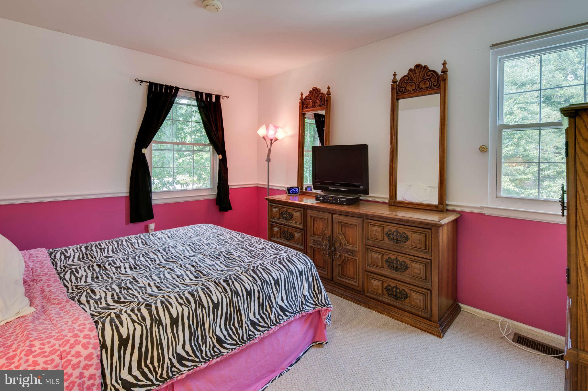 7330 Kindler Road Columbia, MD 21046 - Photo 19 of 28 a bedroom with a bed and a flat screen tv