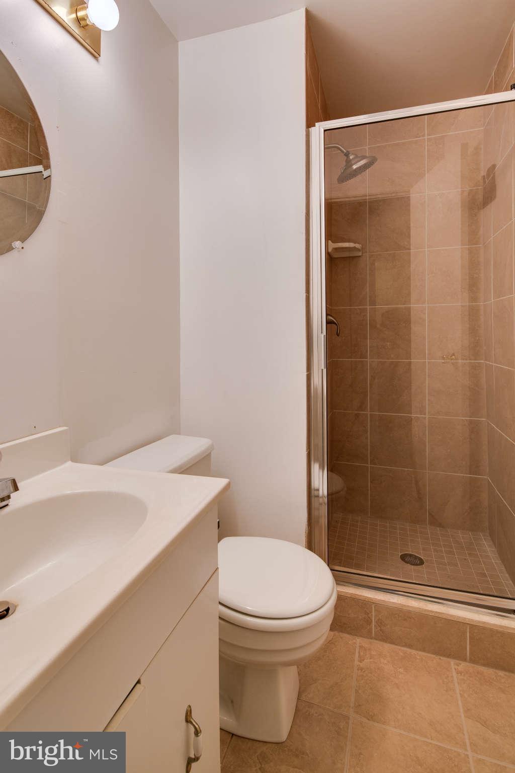 7330 Kindler Road Columbia, MD 21046 - Photo 24 of 28 a bathroom with a sink a toilet and shower