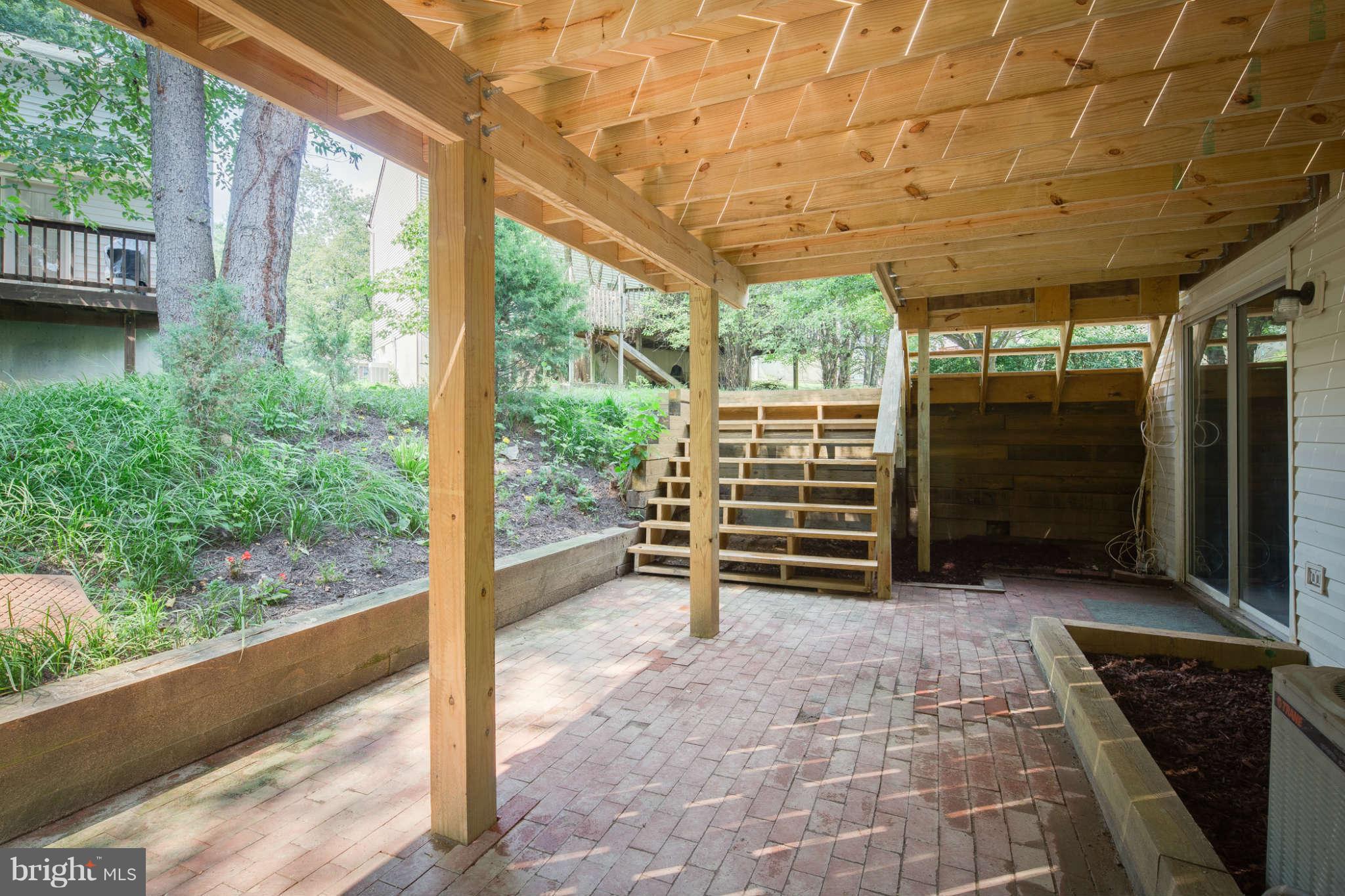 7330 Kindler Road Columbia, MD 21046 - Photo 26 of 28 a backyard of a house with wooden floor and outdoor seating