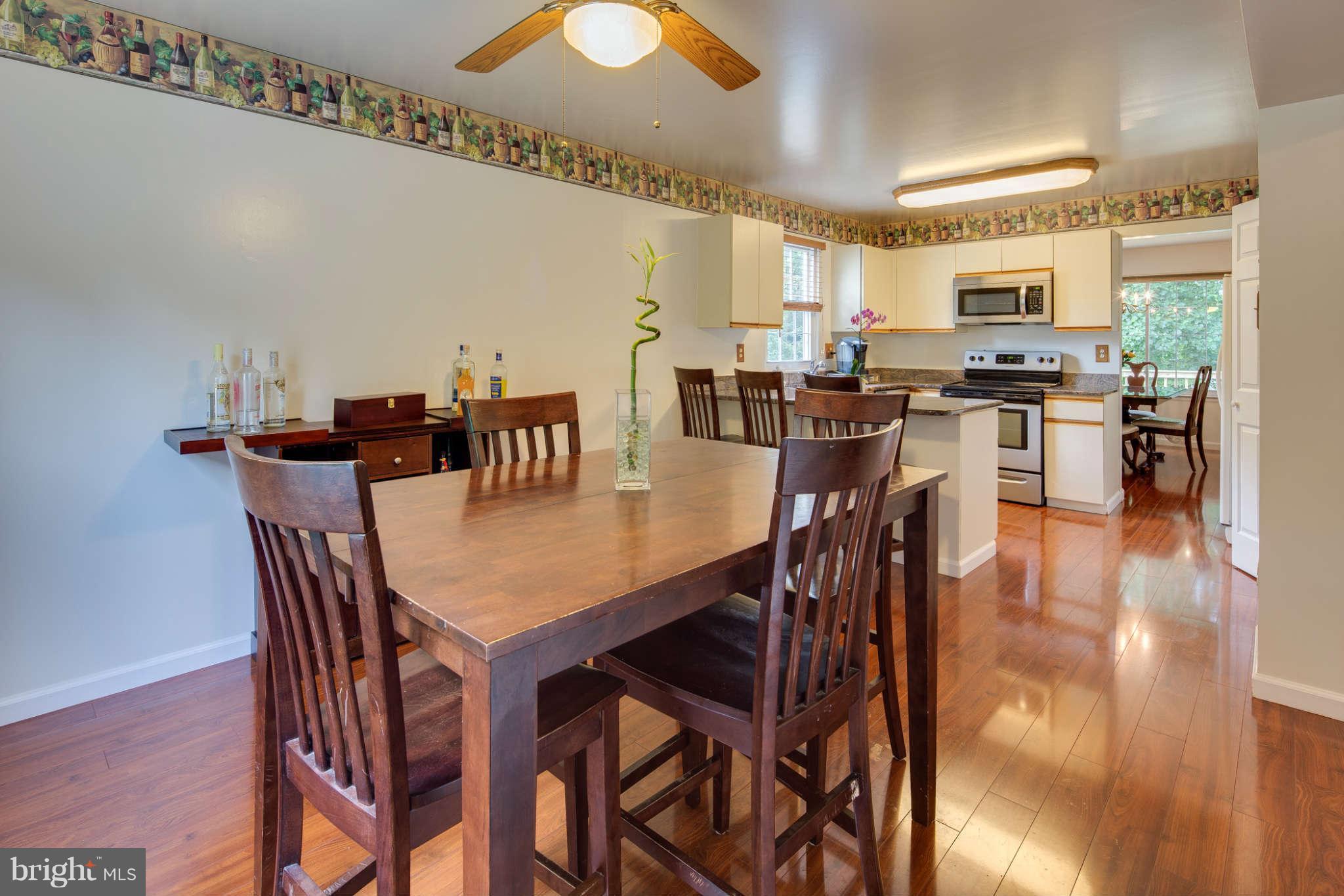7330 Kindler Road Columbia, MD 21046 - Photo 8 of 28 a view of a dining room with furniture and wooden floor