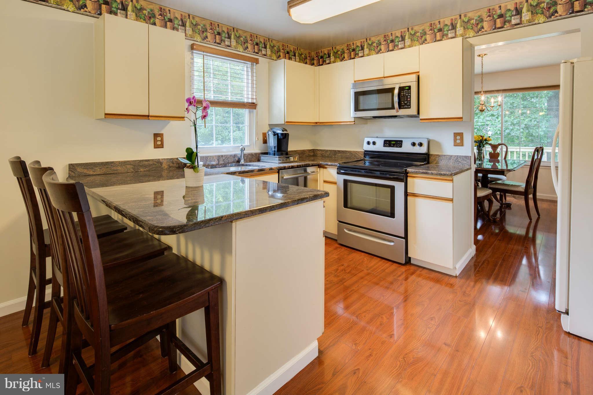 7330 Kindler Road Columbia, MD 21046 - Photo 9 of 28 a kitchen with a stove a sink and a microwave