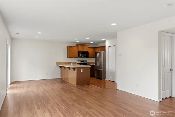 a kitchen with a refrigerator and a stove top oven