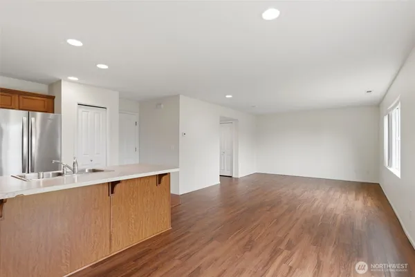 a view of cabinets with wooden floor and window