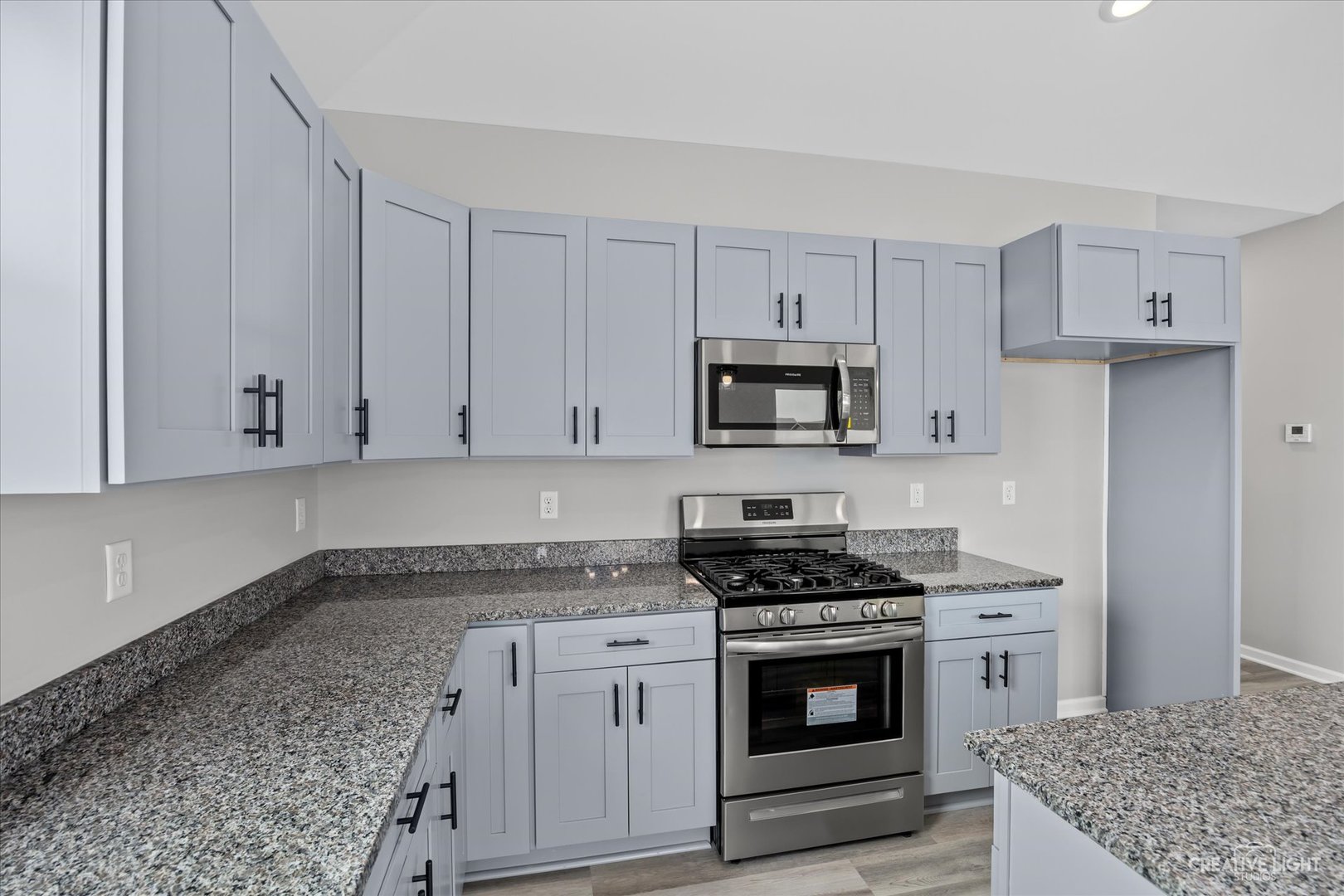 534 Hahn Drive Cortland, IL 60112 - Photo 12 of 32 a kitchen with granite countertop white cabinets and stainless steel appliances