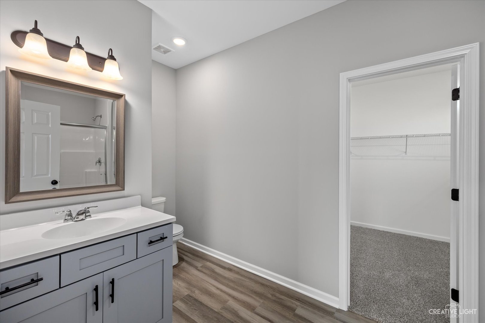 534 Hahn Drive Cortland, IL 60112 - Photo 19 of 32 a bathroom with a sink a vanity and a mirror