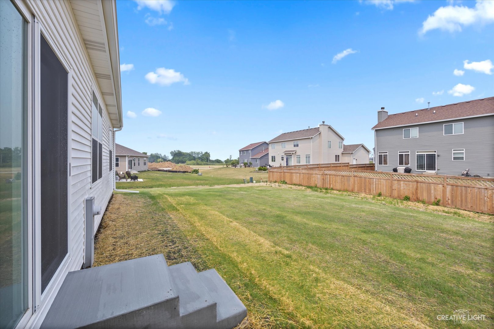 534 Hahn Drive Cortland, IL 60112 - Photo 24 of 32 a view of an house with backyard outdoor space and balcony