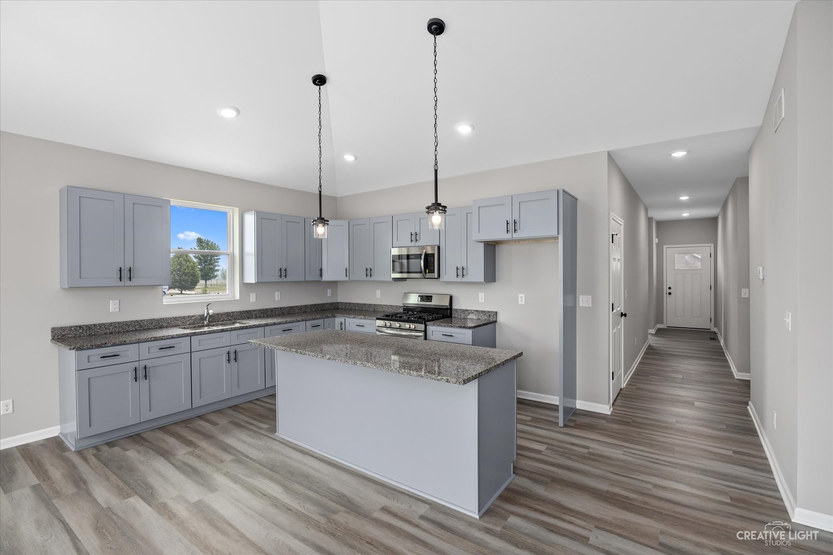 534 Hahn Drive Cortland, IL 60112 - Photo 9 of 32 a large kitchen with stainless steel appliances kitchen island granite countertop a sink and a refrigerator