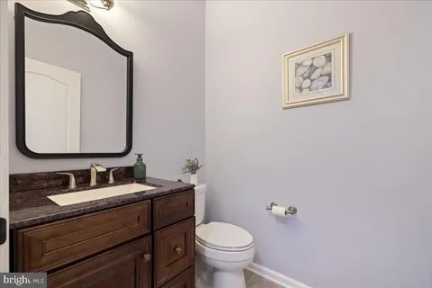 a living room with furniture and a fireplace with wooden floor