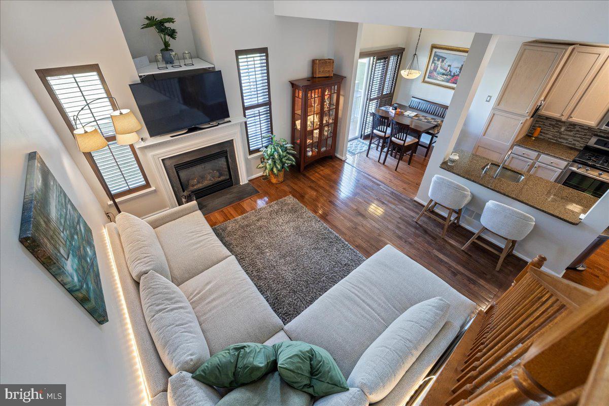 211 Barness Lane Chalfont, PA 18914 - Photo 11 of 32 a living room with furniture a flat screen tv and a fireplace