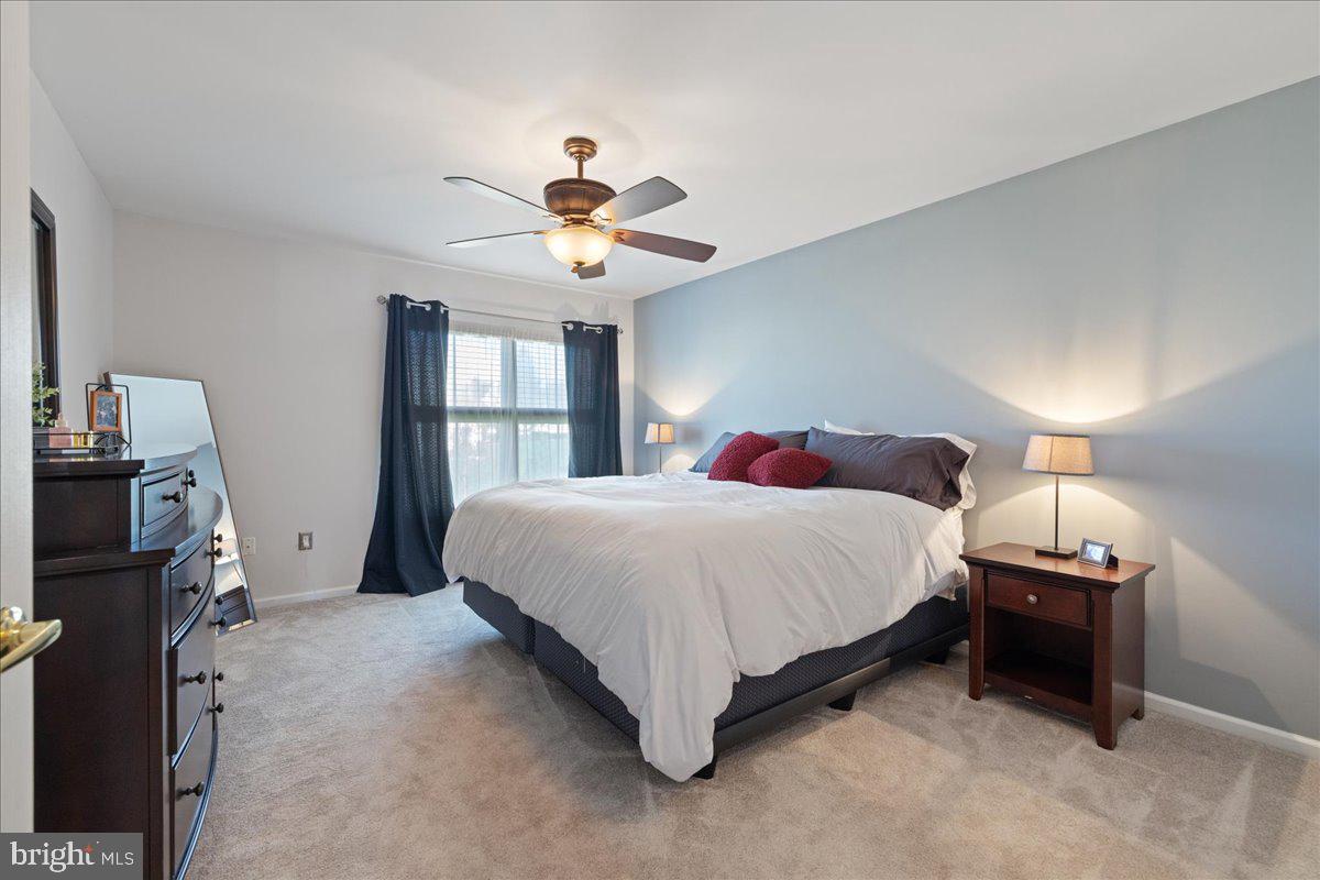 211 Barness Lane Chalfont, PA 18914 - Photo 12 of 32 a spacious bedroom with a bed and a chandelier