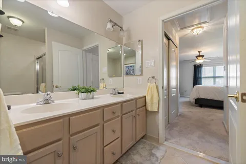 a spacious bedroom with a bed and a chandelier