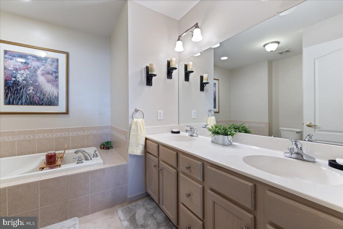 211 Barness Lane Chalfont, PA 18914 - Photo 14 of 32 a bathroom with a tub a sink double and mirror