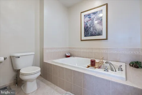 a bathroom with a tub a sink double and mirror