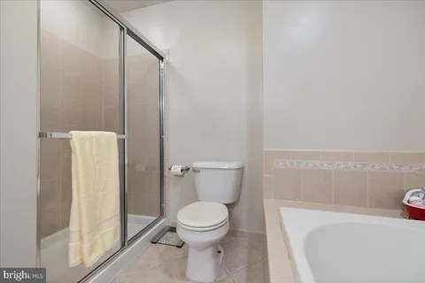 a white toilet sitting next to a bathroom sink
