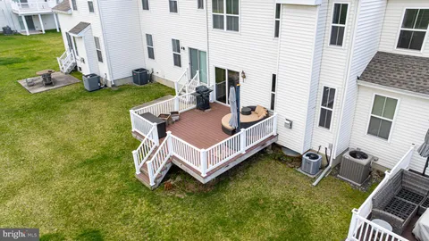 an outdoor living room with patio furniture and a yard