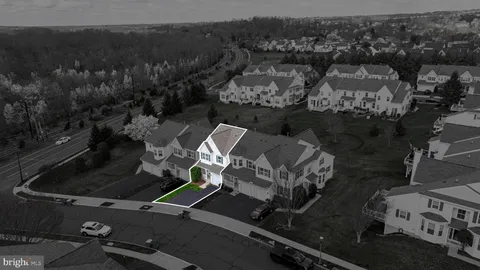 a view of a big house with a big yard and large trees