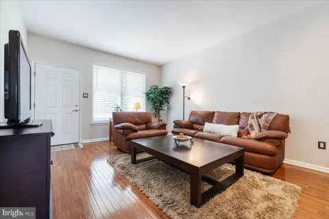 a living room with furniture a rug and a flat screen tv