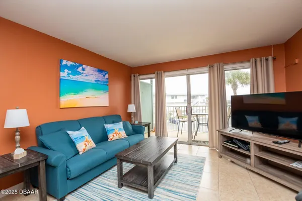 a living room with furniture and a flat screen tv