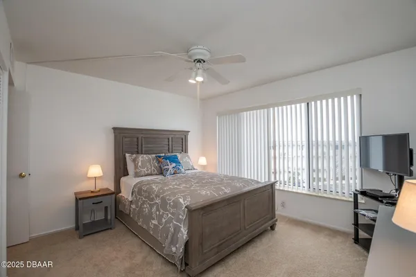 a bedroom with a bed and a tv on table