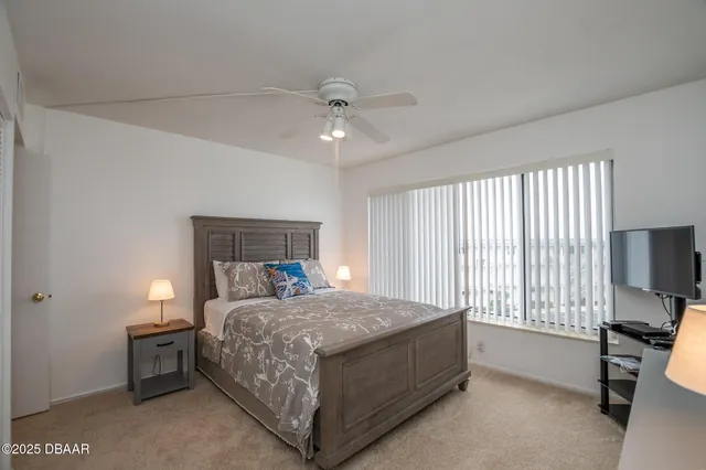 a bedroom with a bed and a tv on table