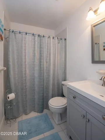 a bathroom with a granite countertop sink toilet and a mirror