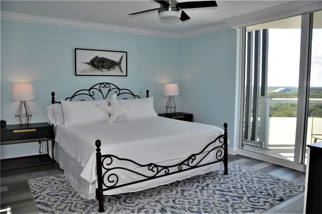 a bedroom with a bed and glass window