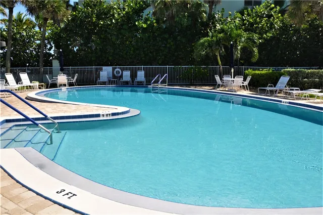 a view of a swimming pool with a patio
