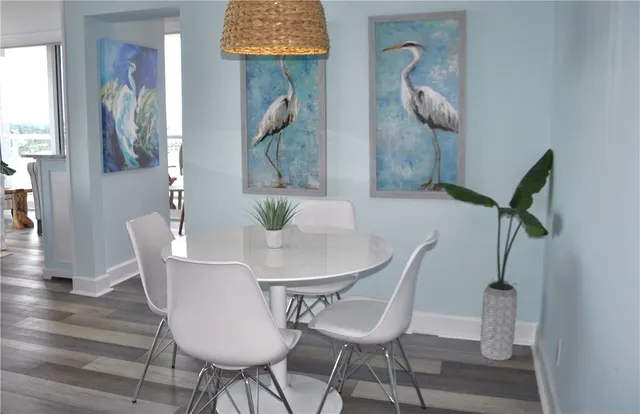 a dining room with furniture and wooden floor