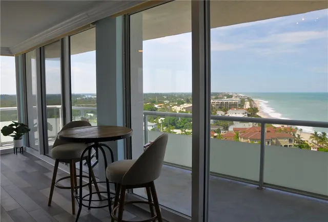 a view of a dining room with furniture and window