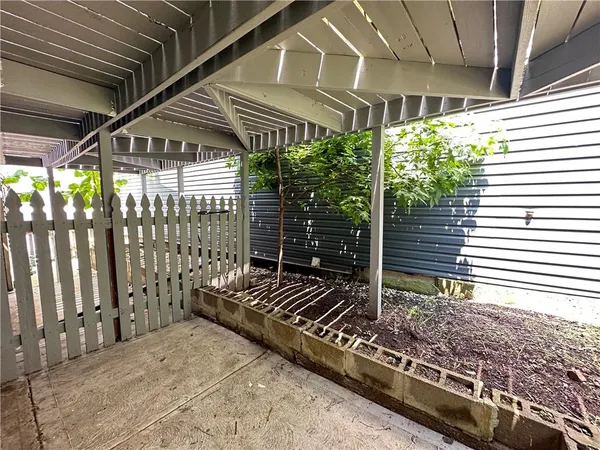 a view of a porch with wooden floor and fence