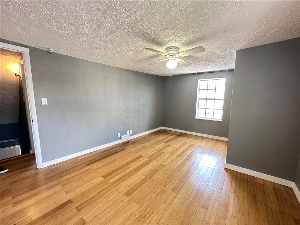 513 52nd Street Pittsburgh, PA 15201 - Photo 5 of 14 an empty room with wooden floor and windows