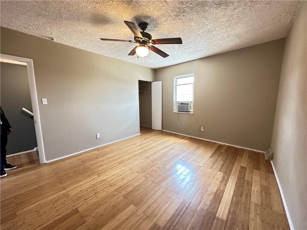 513 52nd Street Pittsburgh, PA 15201 - Photo 7 of 14 an empty room with wooden floor fan and windows