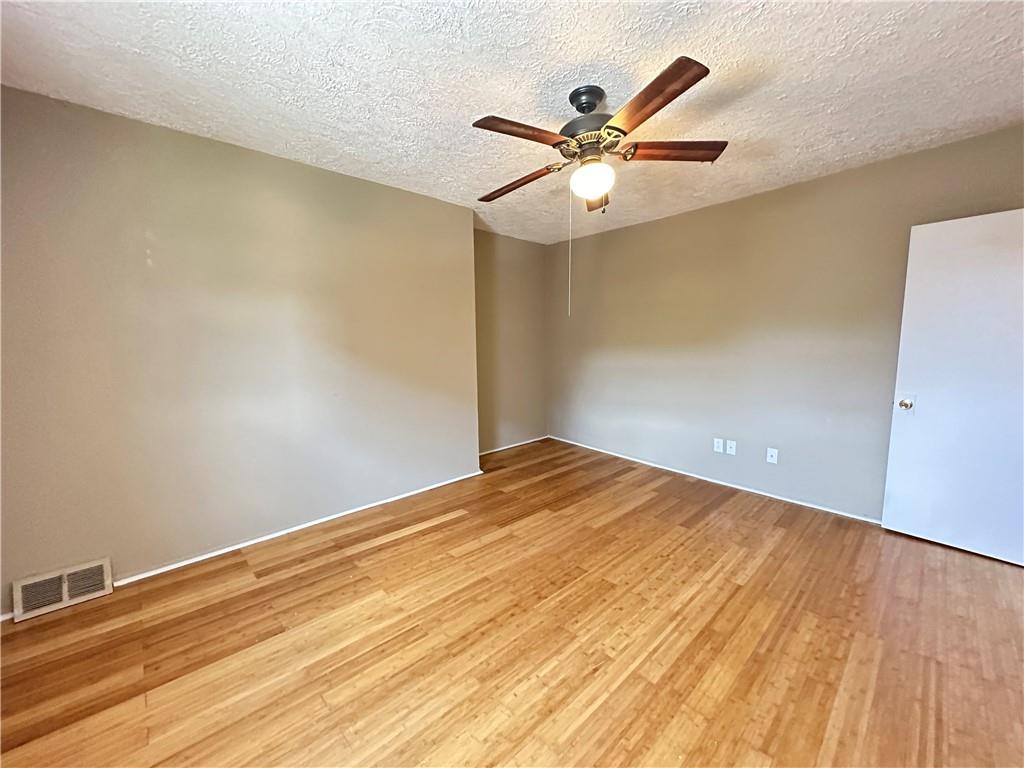 513 52nd Street Pittsburgh, PA 15201 - Photo 8 of 14 a view of a big room with wooden floor and a ceiling fan