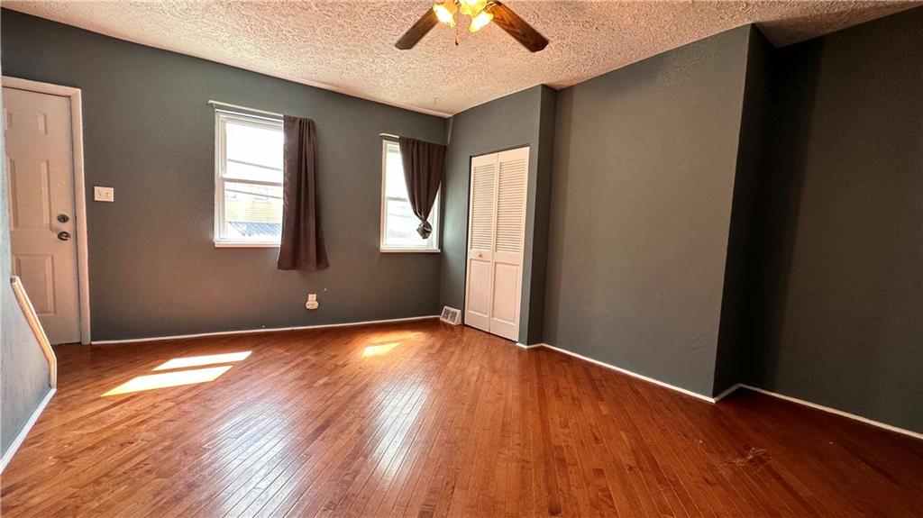513 52nd Street Pittsburgh, PA 15201 - Photo 9 of 14 an empty room with wooden floor chandelier fan and windows